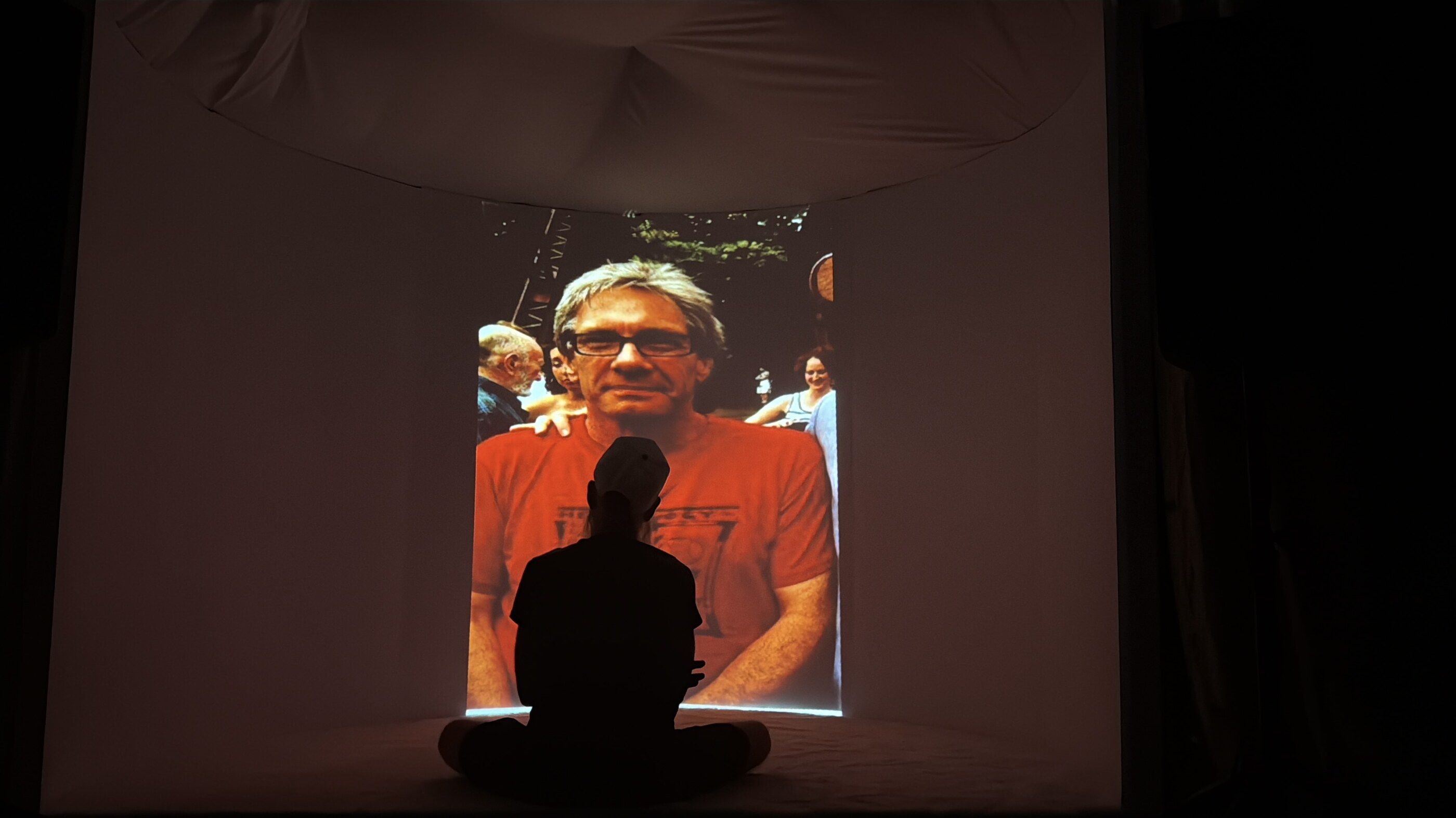 A photograph a visitor uploaded, projected across the curved wall as it is turned into music.